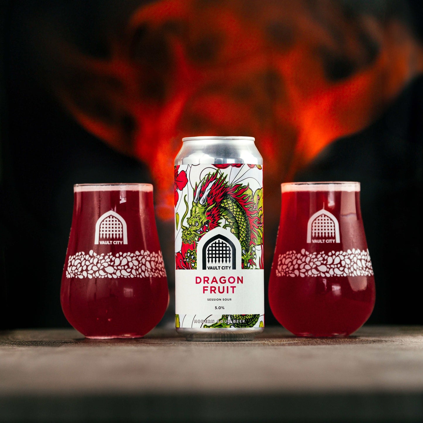 "Dragon Fruit Session Sour beer can with two glasses, showcasing fiery design and tropical flavors"