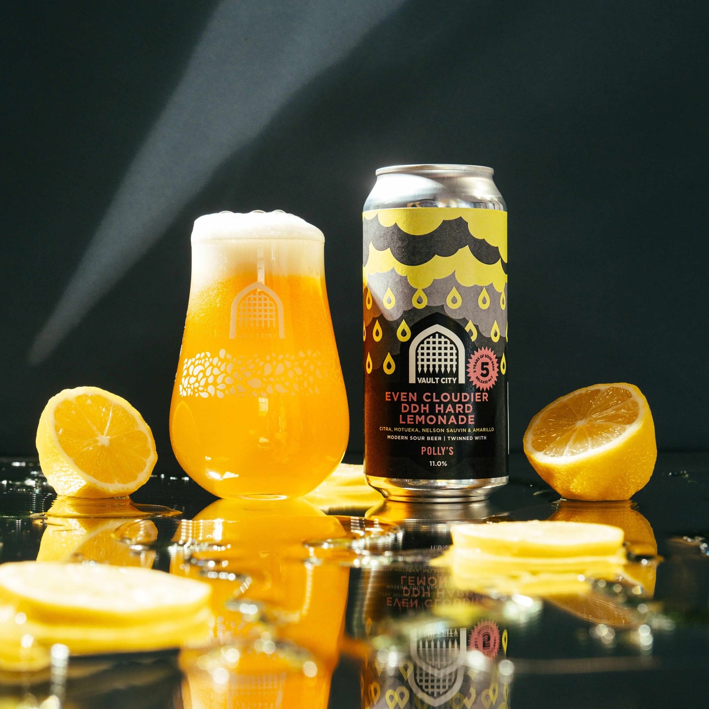 Even Cloudier DDH Hard Lemonade by Vault City x Polly's, celebratory beer with citrus and tropical fruit flavors, glass and can with lemon slices