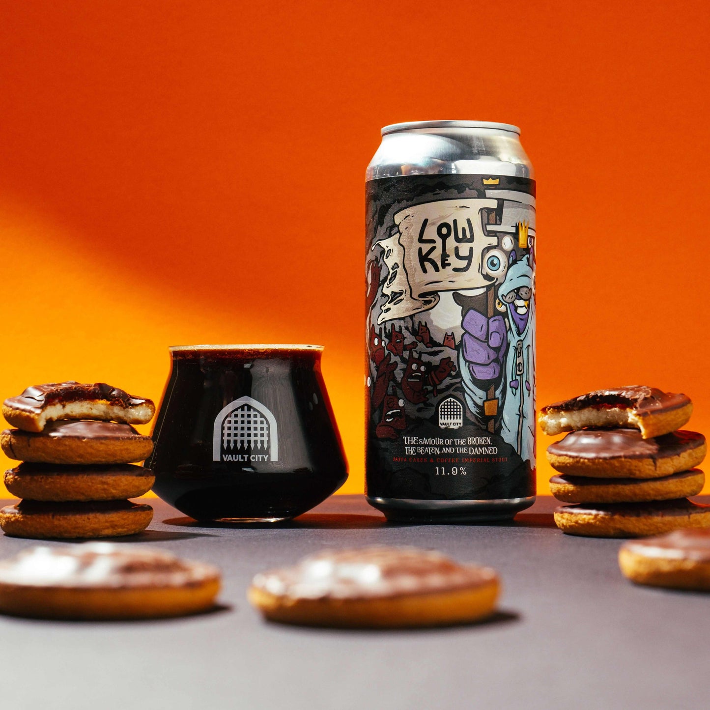 "The Saviour of the Broken, the Beaten, and the Damned Jaffa Cakes & Coffee Imperial Stout can and glass amidst Jaffa cakes"