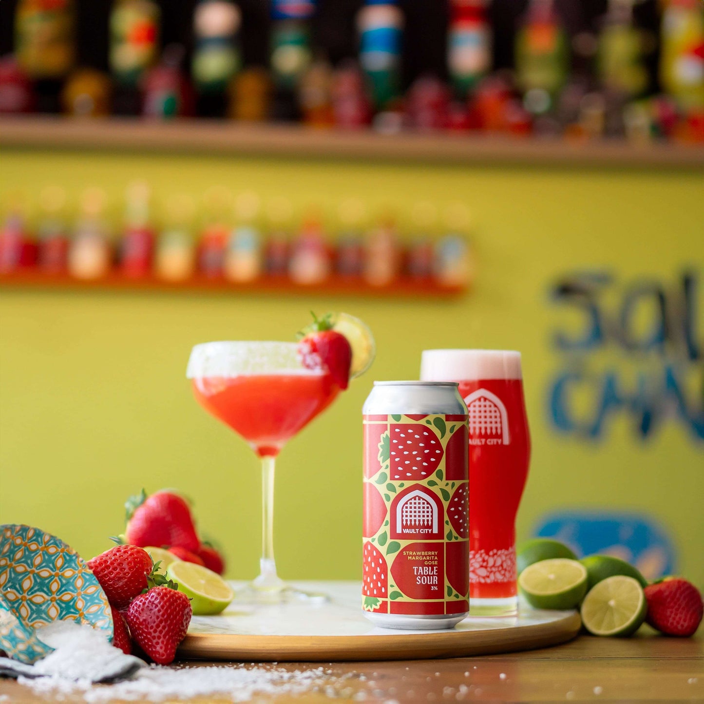 Strawberry Margarita Gose Table Sour with fresh strawberries, limes, and salt on wooden tray, showcasing vibrant, fruity cocktail-inspired Gose.