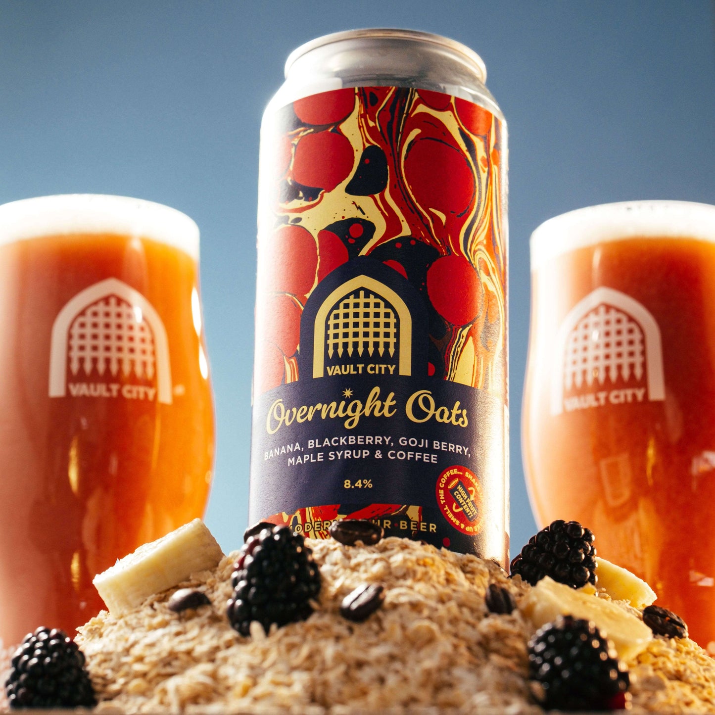 Overnight Oats beer can with banana, blackberry, goji berry, maple, coffee, flanked by two glasses of golden oat-based breakfast style beer.