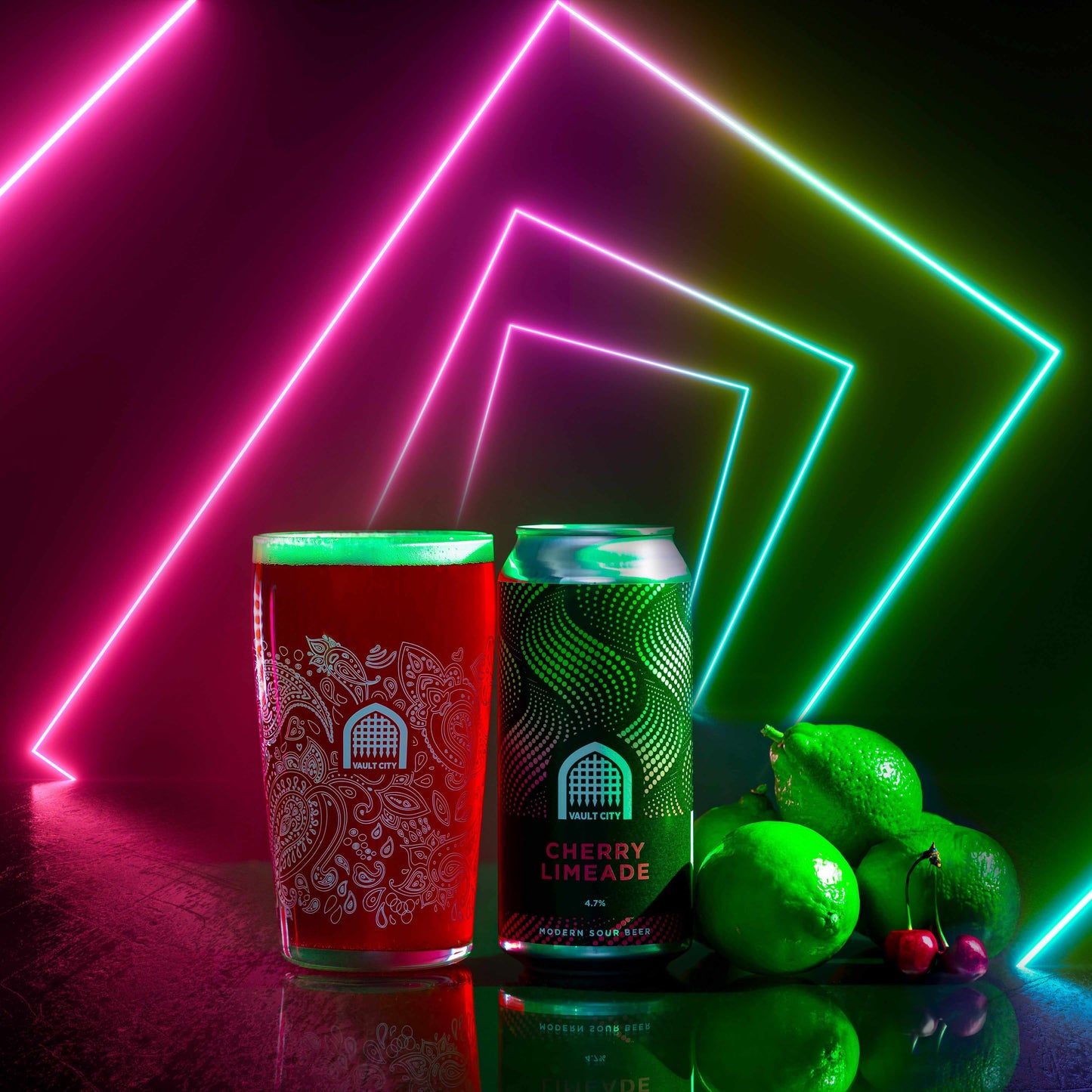 Glass and can of Cherry Limeade sour beer with fresh limes and cherries, illuminated by neon lights.