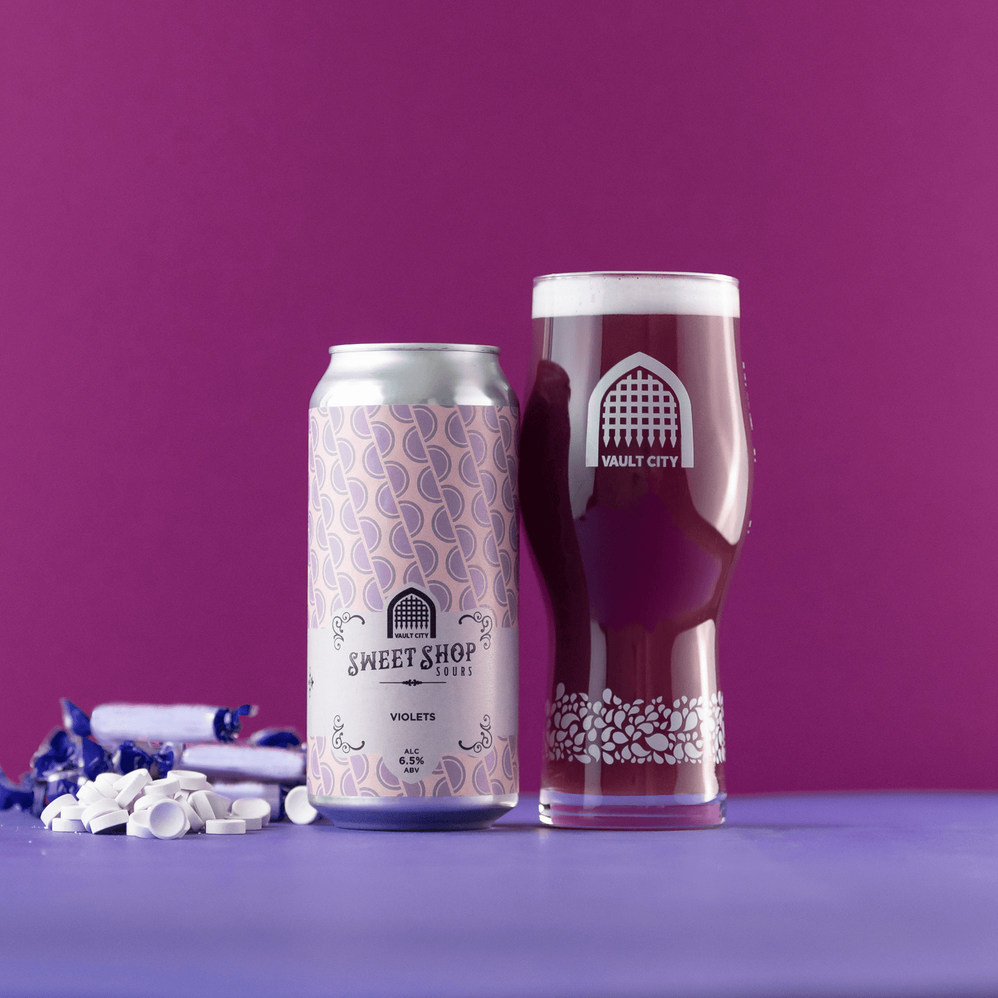 Can and glass of Violets sour beer with floral flavor, set against a purple backdrop with nostalgic candy.
