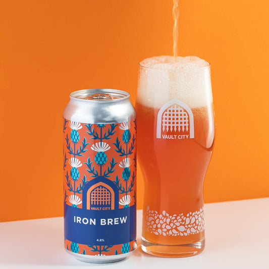 Can and glass of Iron Brew with bold orange color and Vault City branding, showcasing Scotland's iconic beverage.