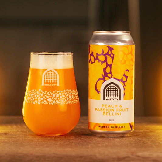 Vault City Peach & Passion Fruit Bellini sour beer in glass and can, 6.6%, 440ml, juicy peach and passion fruit flavor burst.