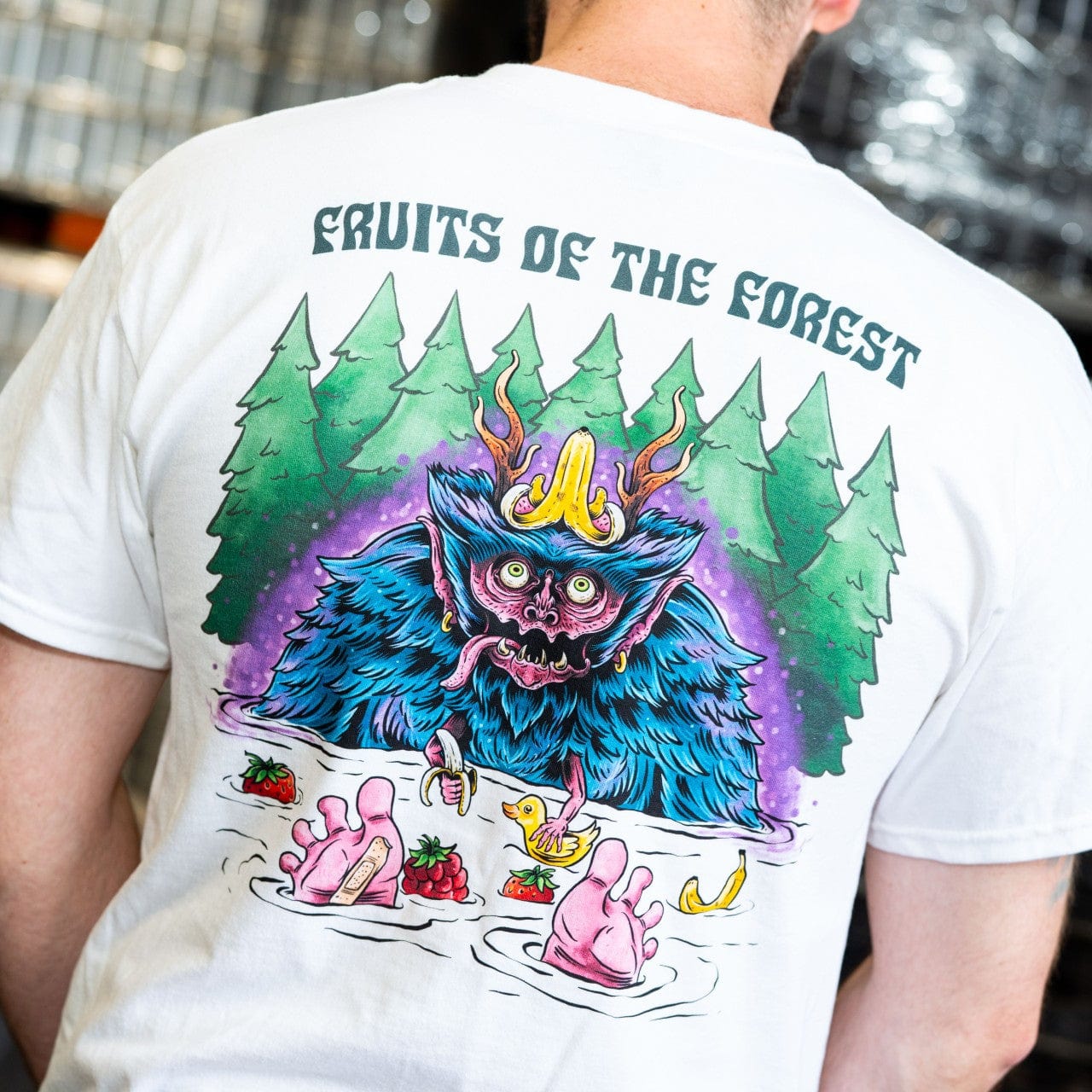 Fruits of the Forest Tee featuring colourful artwork by Stuart Allan with forest backdrop and unique creature design