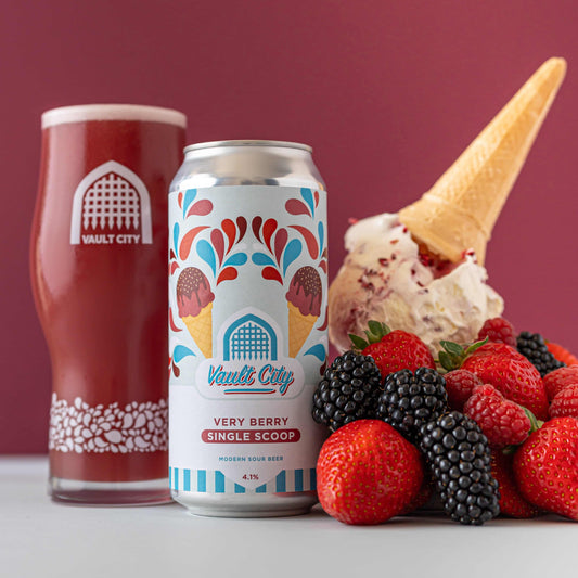 Can of Very Berry Single Scoop with glass and fresh berries on light gray and maroon background