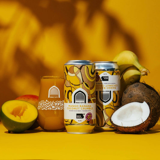 Vault City x Bereta Mango Banana Coconut Crumble smoothie sour beer cans surrounded by mango, banana, and coconut.