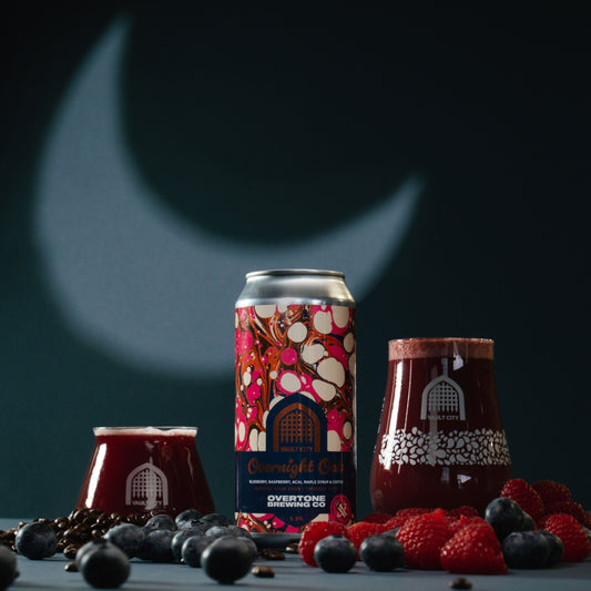 Overnight Oats breakfast beer with blueberries, raspberries, and coffee by Vault City x Overtone in front of moon backdrop.